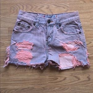 Levi’s pink dyed distressed shorts